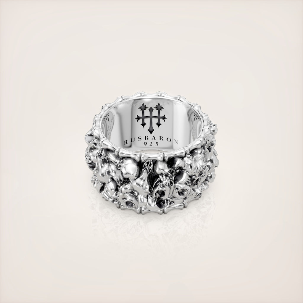 Silver ring with intricate design on a light gray background